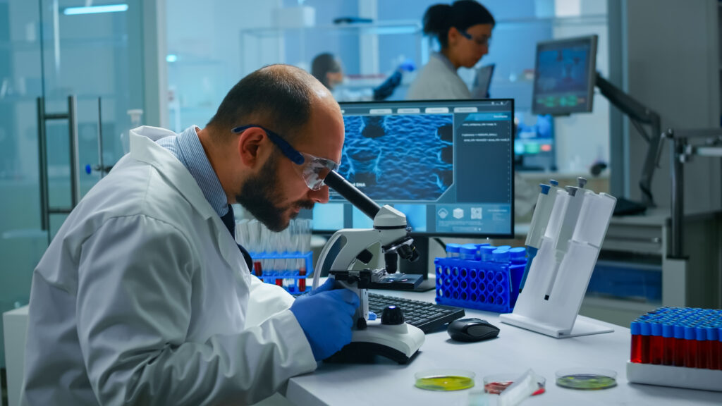 Home medical research scientist conducting vaccine development digital microscope biological applied science laboratory